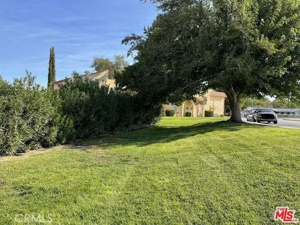 a kitchen with a refrigerator a stove top oven and cabinets