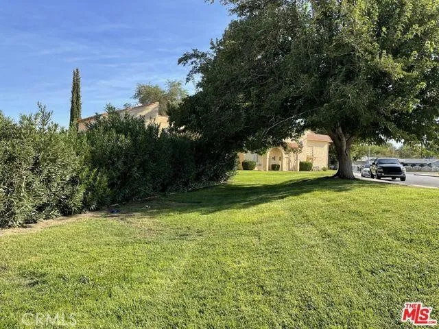 a kitchen with a refrigerator a stove top oven and cabinets