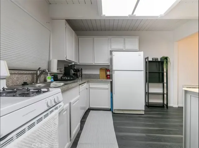 a kitchen with a stove a refrigerator and a sink