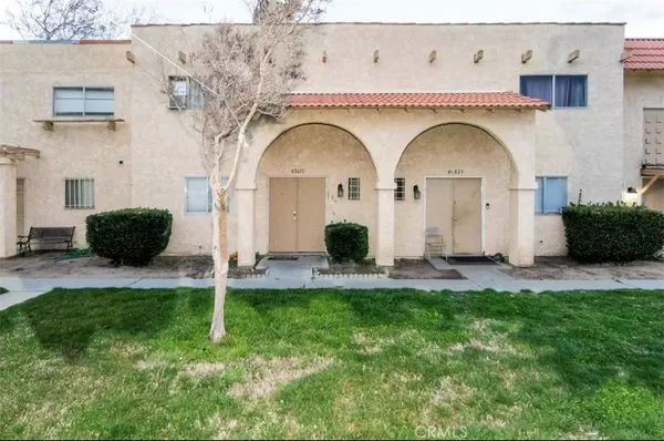 a view of a hallway with wooden floor and closet