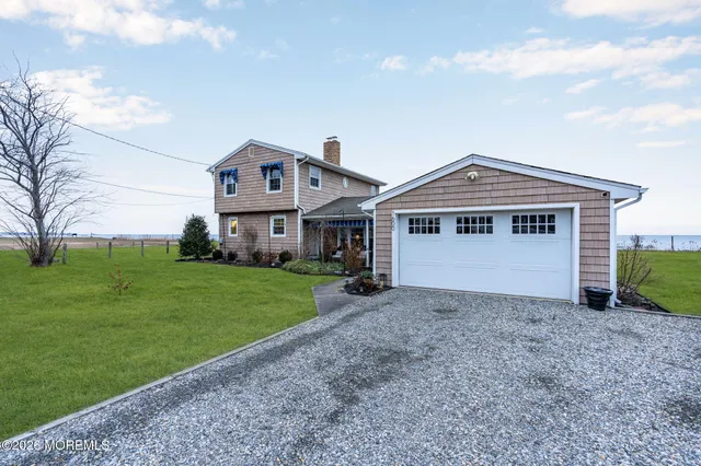 a view of a dining room and livingroom with furniture window and wooden floor