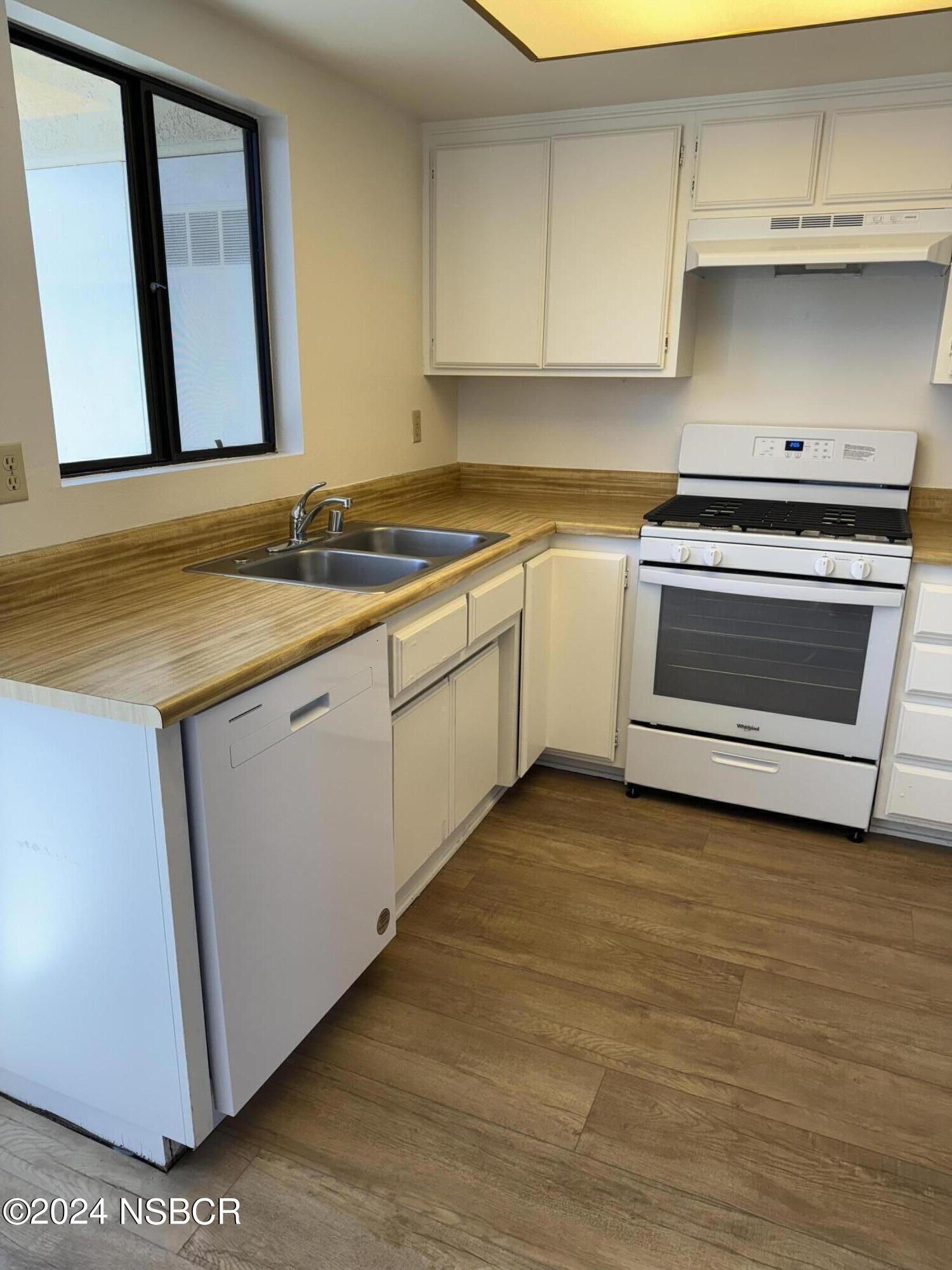 1218 East Walnut Avenue, Unit B Lompoc, CA 93436 - Photo 3 of 11 a kitchen with a sink stove and cabinets