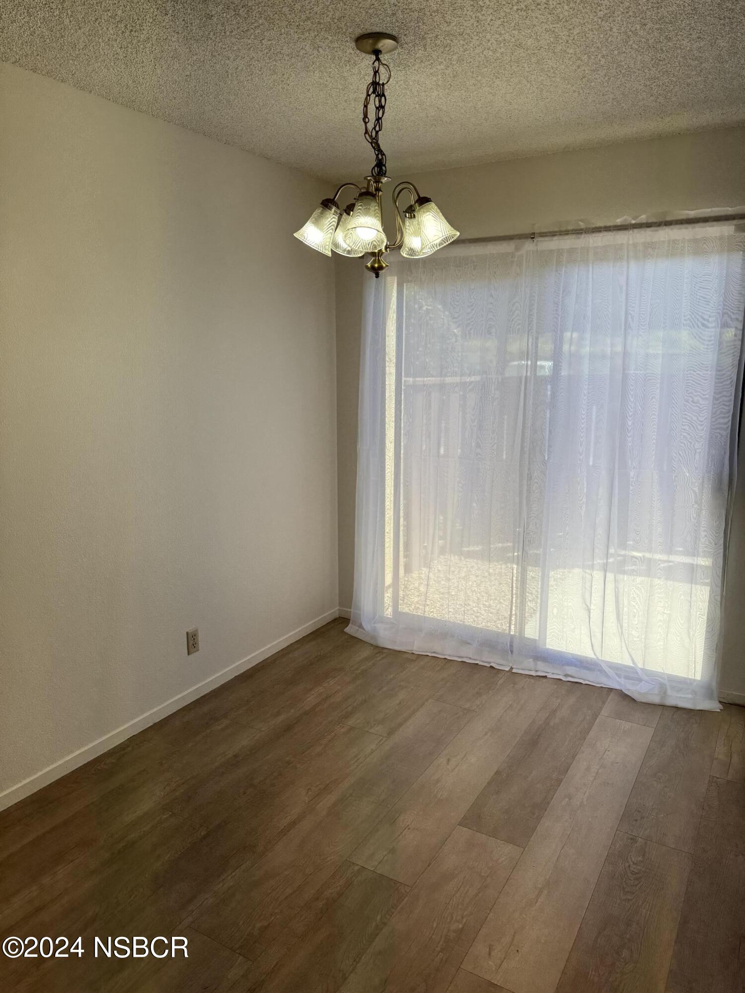 1218 East Walnut Avenue, Unit B Lompoc, CA 93436 - Photo 4 of 11 a view of an empty room with a window