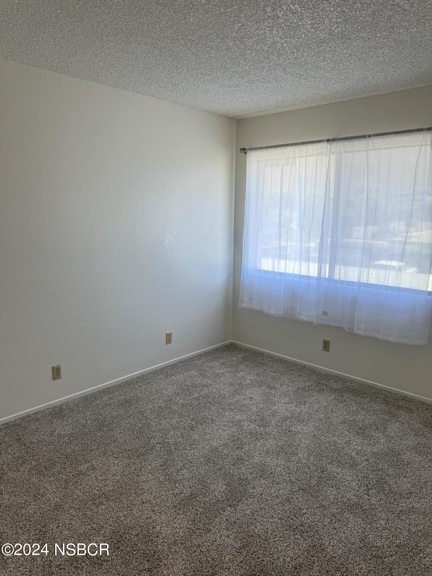 1218 East Walnut Avenue, Unit B Lompoc, CA 93436 - Photo 8 of 11 a view of an empty room and window