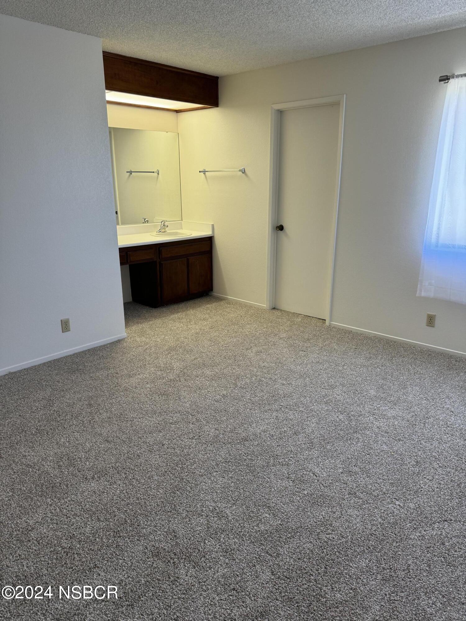 1218 East Walnut Avenue, Unit B Lompoc, CA 93436 - Photo 9 of 11 an empty room with a window
