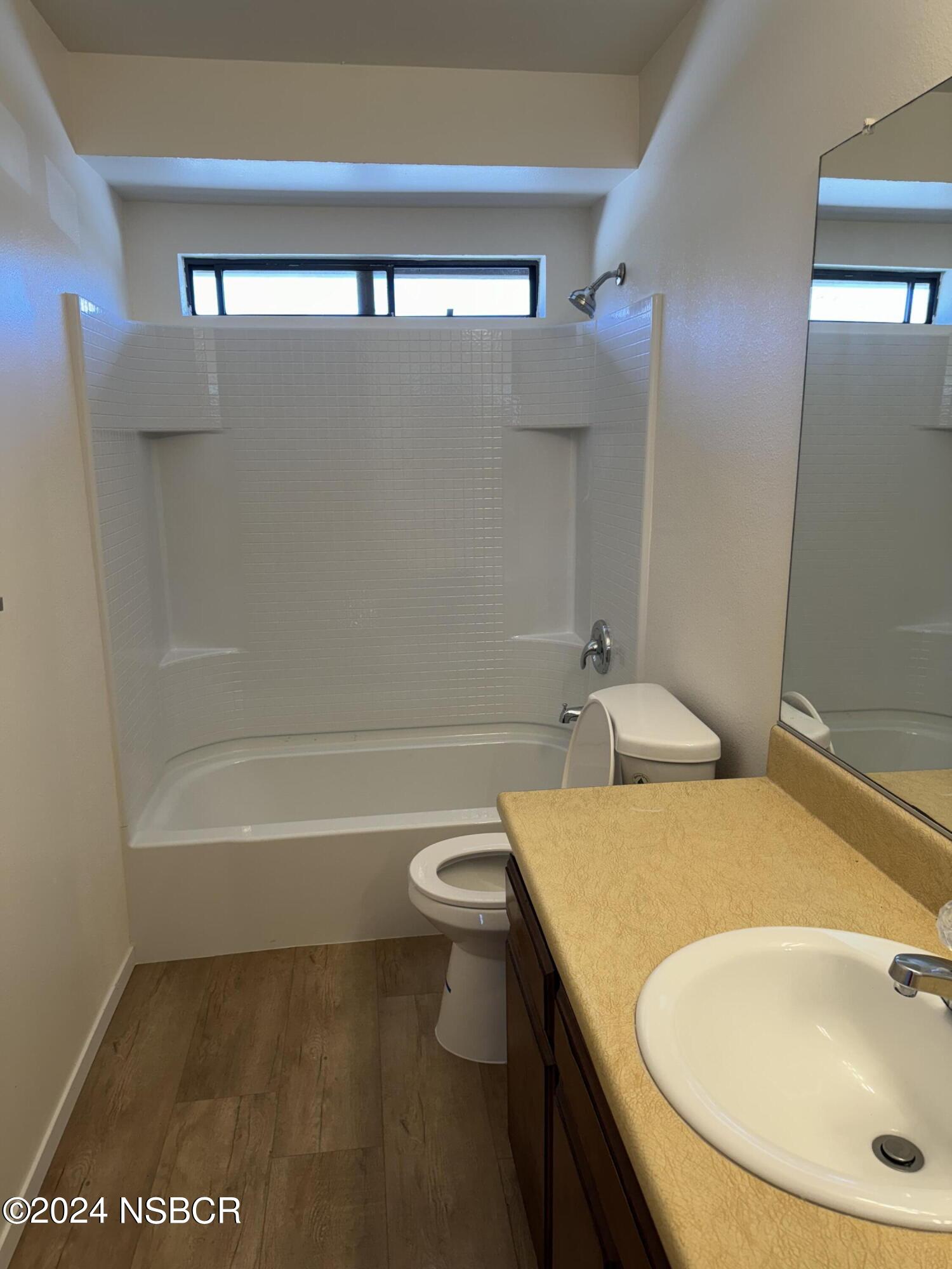 1218 East Walnut Avenue, Unit B Lompoc, CA 93436 - Photo 10 of 11 a bathroom with a sink a toilet and shower