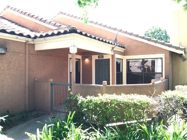 10655 Lemon Avenue, Unit 803 Rancho Cucamonga, CA 91737 - Photo 1 of 1 a view of a house with a small yard and potted plants