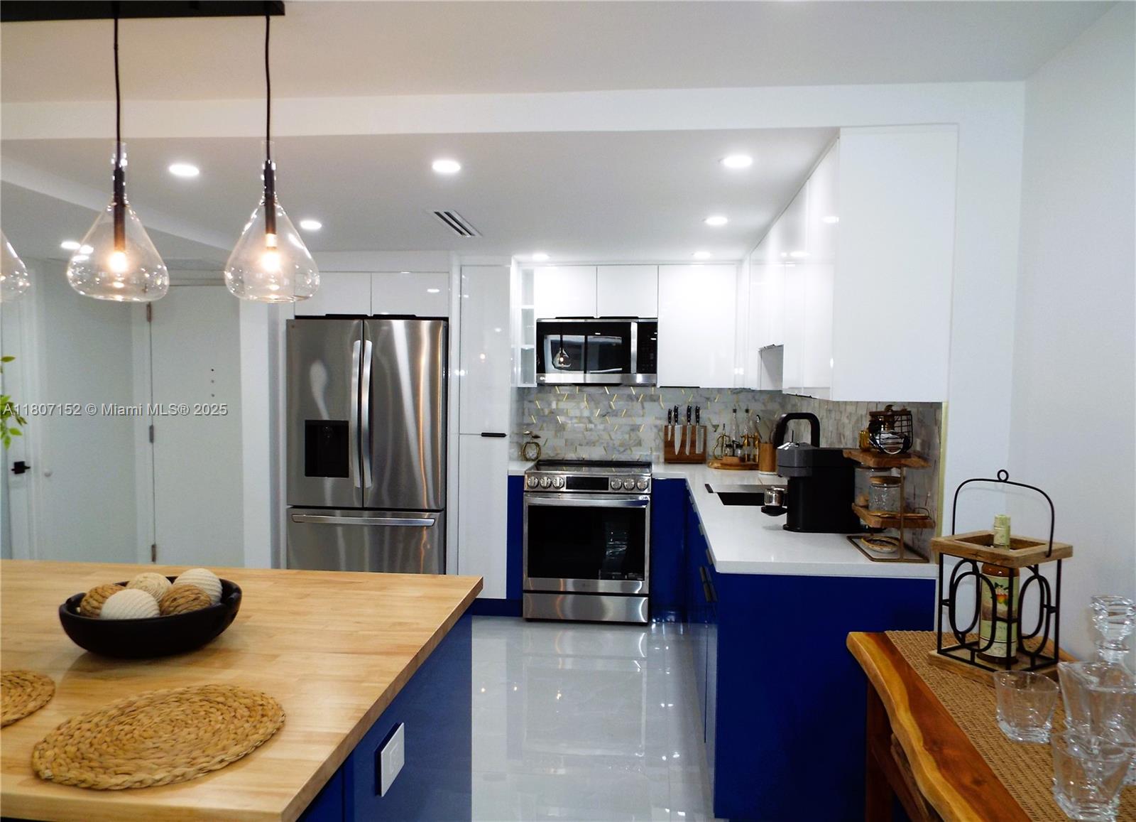 5701 Collins Avenue, Unit 1619 Miami Beach, FL 33140 - Photo 14 of 77 a kitchen with sink and refrigerator