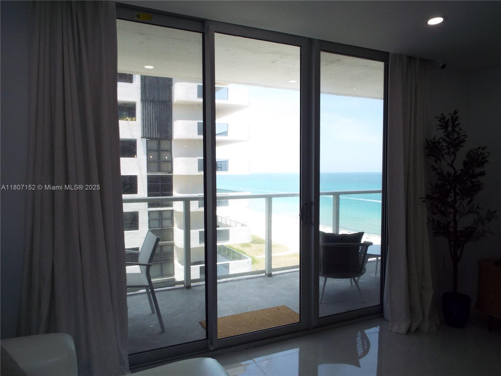 5701 Collins Avenue, Unit 1619 Miami Beach, FL 33140 - Photo 46 of 77 a view of a glass door and an empty room with glass door