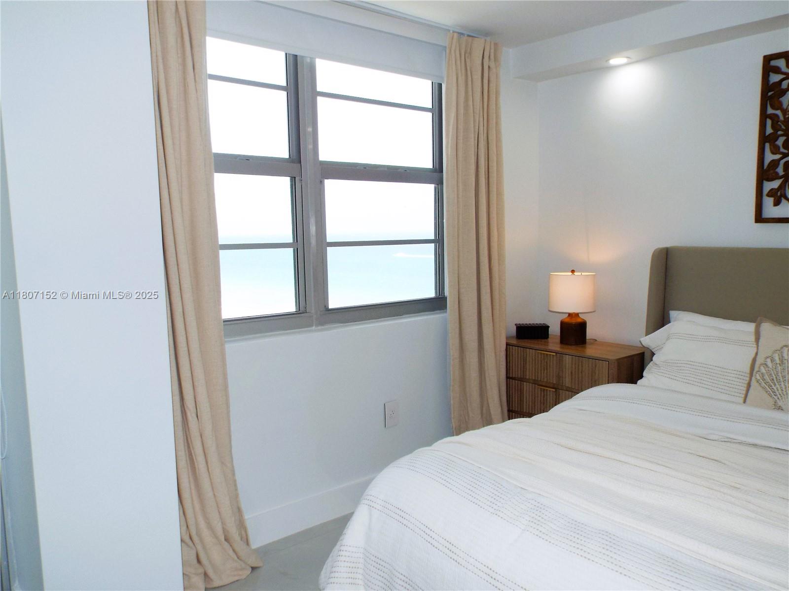 5701 Collins Avenue, Unit 1619 Miami Beach, FL 33140 - Photo 47 of 77 a bedroom with a bed and a window