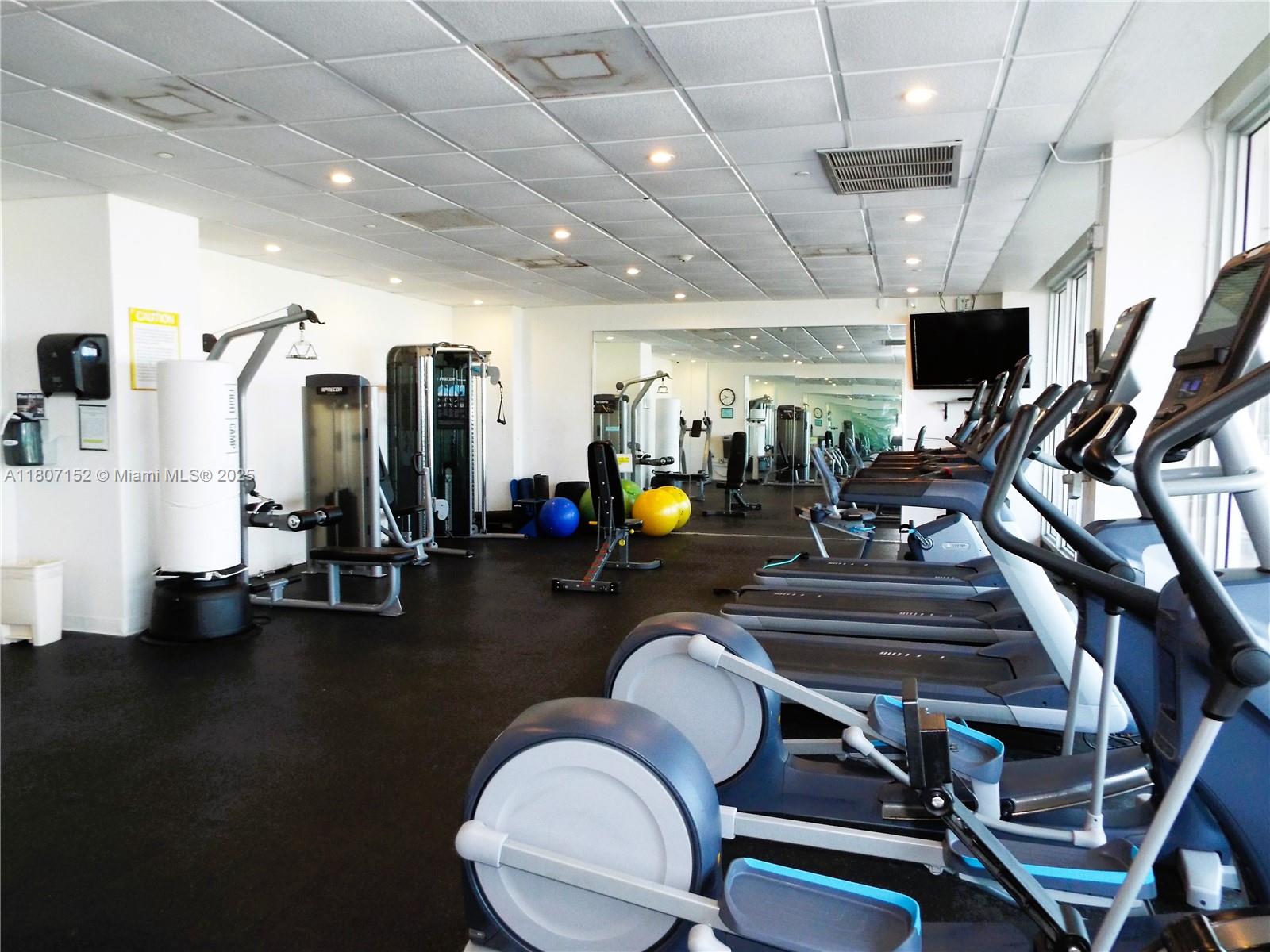 5701 Collins Avenue, Unit 1619 Miami Beach, FL 33140 - Photo 59 of 77 a room with gym equipment and a large window