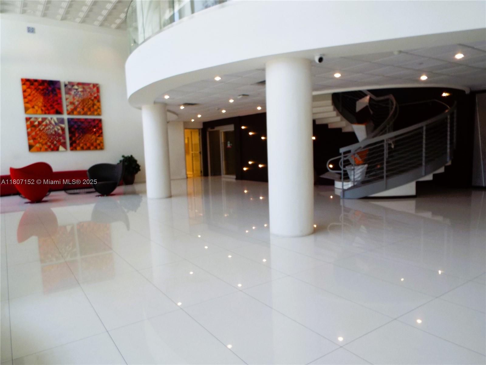 5701 Collins Avenue, Unit 1619 Miami Beach, FL 33140 - Photo 72 of 77 a room with furniture and a large window