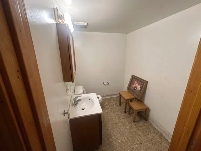 a bathroom with a sink toilet and mirror