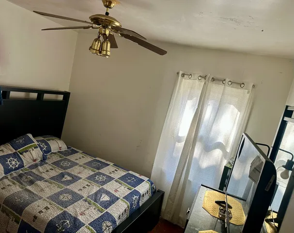 a bedroom with a bed and a mirror