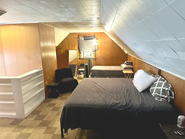 a bedroom with a bed and window