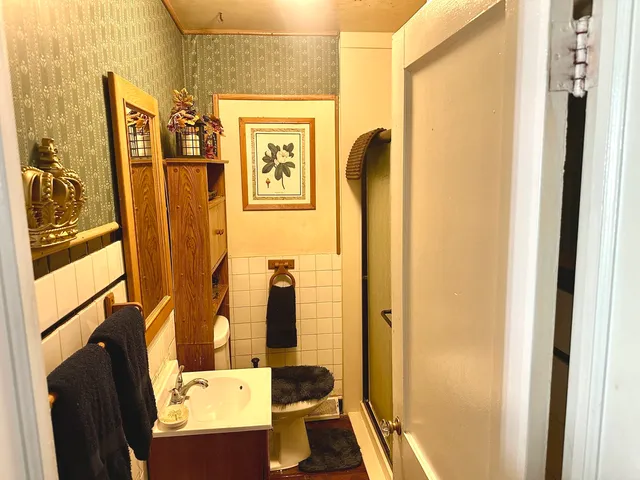 a bathroom with a sink and mirror with bathtub