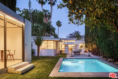 swimming pool view with a garden space