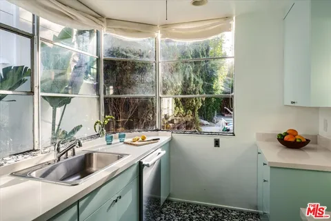 a white stove top oven sitting inside of a kitchen