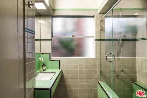 a view of a workspace with furniture and a book shelf