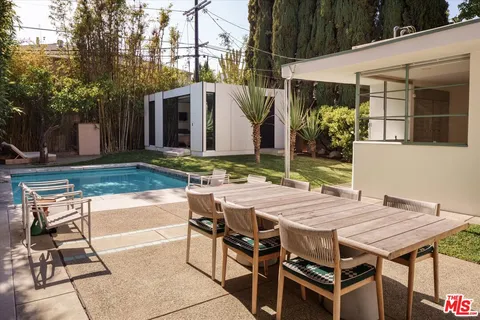 a view of outdoor kitchen with a sink