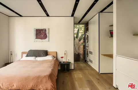 a bedroom with a bed and a large window