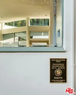 a living room with fireplace furniture and a large window