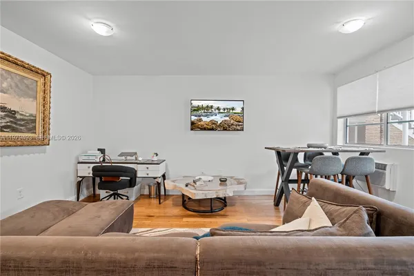 a living room with furniture and a piano