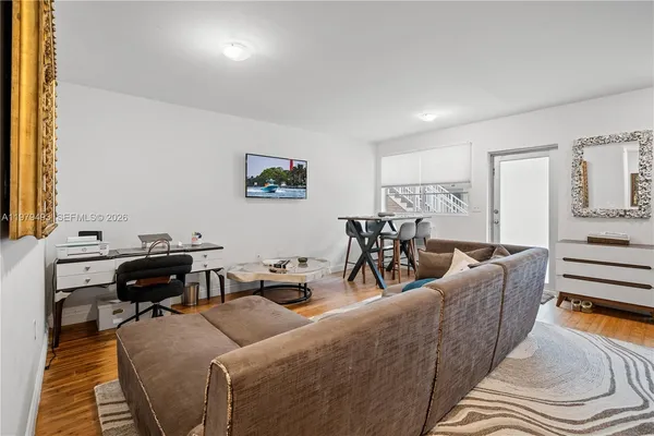 a living room with furniture and wooden floor