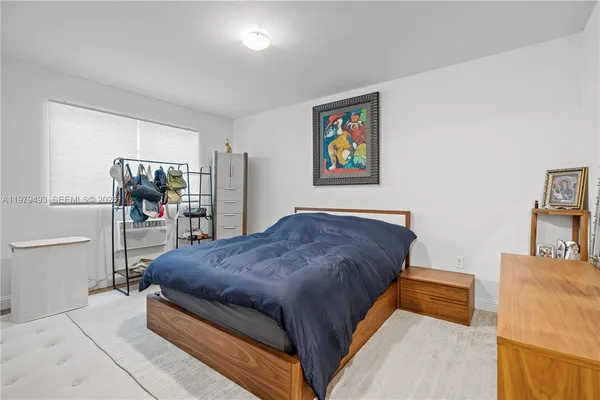 a bedroom with a bed and dresser