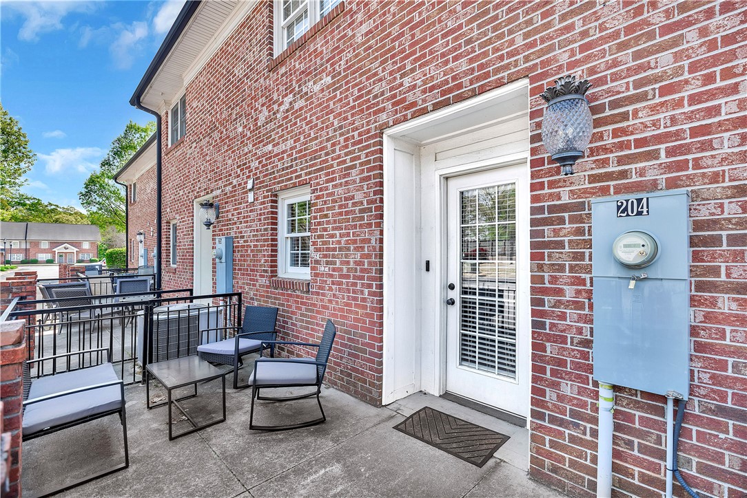 209 Calhoun Street Clemson, SC 29631 - Photo 2 of 25 A private concrete patio sits adjacent to the classic brick exterior.