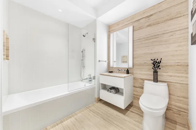 a bathroom with a sink a toilet and bathtub