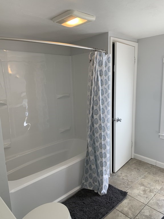525 East County Road Rutland, MA 01543 - Photo 13 of 29 a bathroom with a shower curtain and a toilet