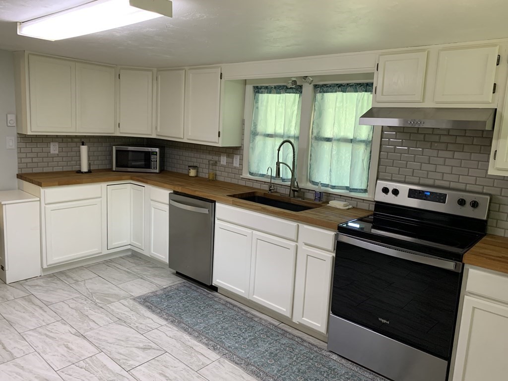 525 East County Road Rutland, MA 01543 - Photo 6 of 29 a kitchen with granite countertop a stove sink and cabinets