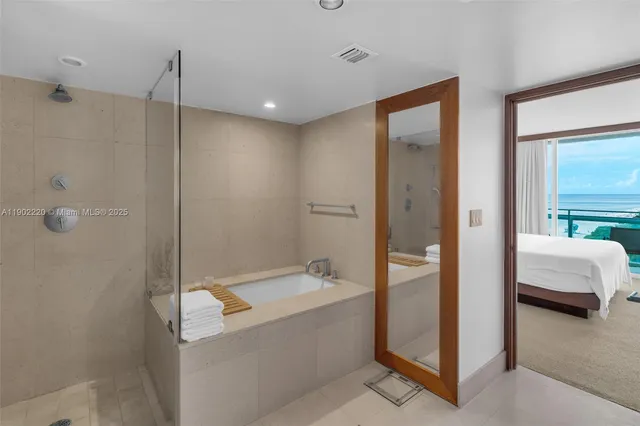 a bathroom with a tub and a shower