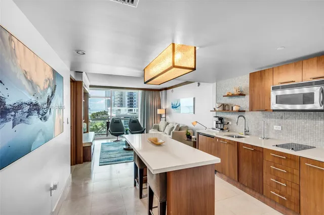 a kitchen with a sink a stove and cabinets