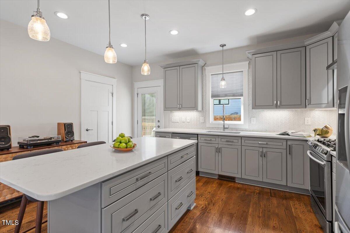 700 Coleman Street Raleigh, NC 27610 - Photo 15 of 44 a kitchen with a sink cabinets and window