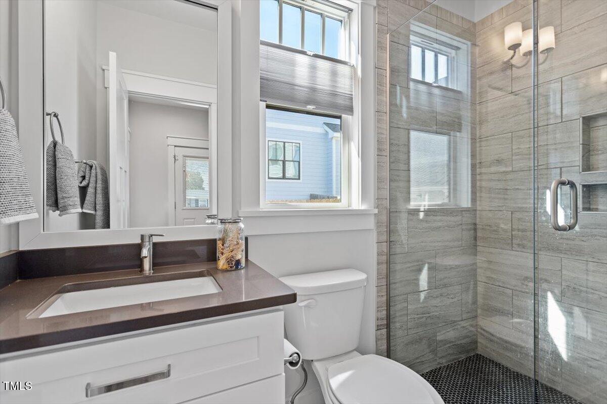 700 Coleman Street Raleigh, NC 27610 - Photo 22 of 44 a bathroom with a sink toilet and shower