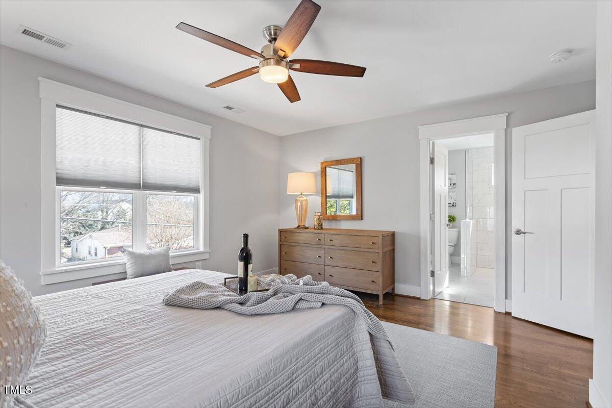 700 Coleman Street Raleigh, NC 27610 - Photo 28 of 44 a bedroom with a bed and wooden floor