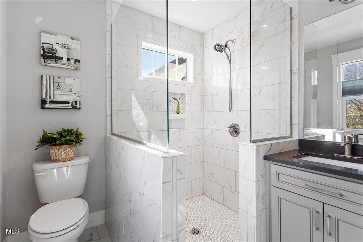 700 Coleman Street Raleigh, NC 27610 - Photo 30 of 44 a bathroom with a granite countertop sink toilet and shower
