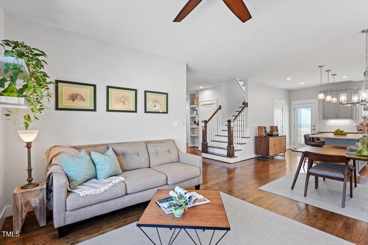 700 Coleman Street Raleigh, NC 27610 - Photo 8 of 44 a living room with furniture kitchen view and a wooden floor