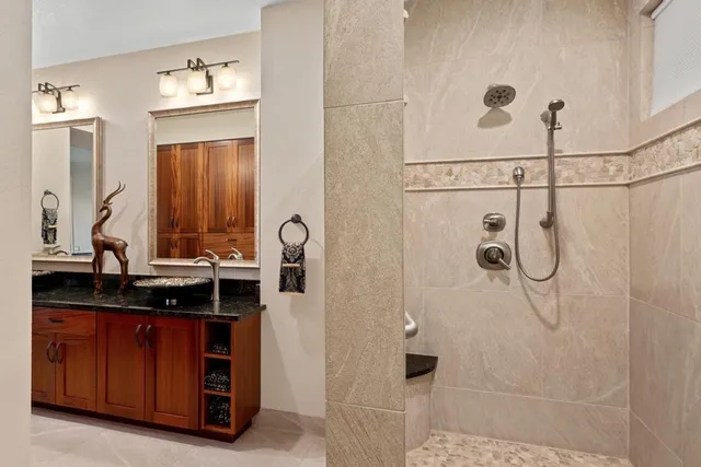 a bathroom with a double vanity sink a mirror and shower