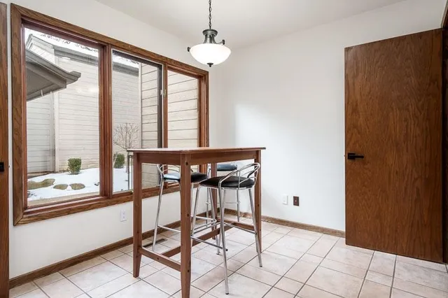 a view of staircase with lots of frames on wall and wooden floor