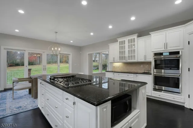a kitchen with stainless steel appliances granite countertop a stove and a sink