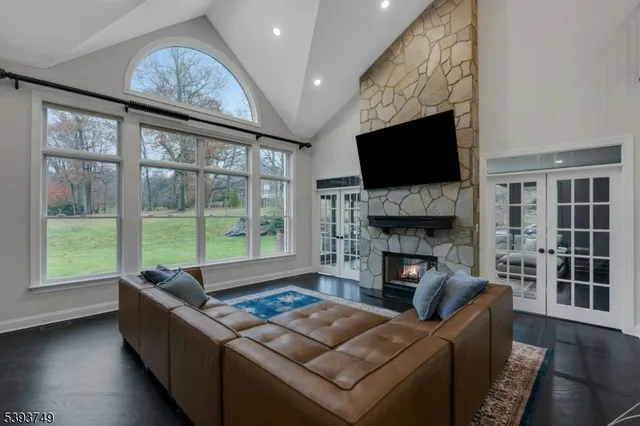 a living room with furniture a flat screen tv and a fireplace