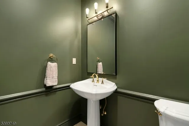 a bathroom with a sink toilet and mirror