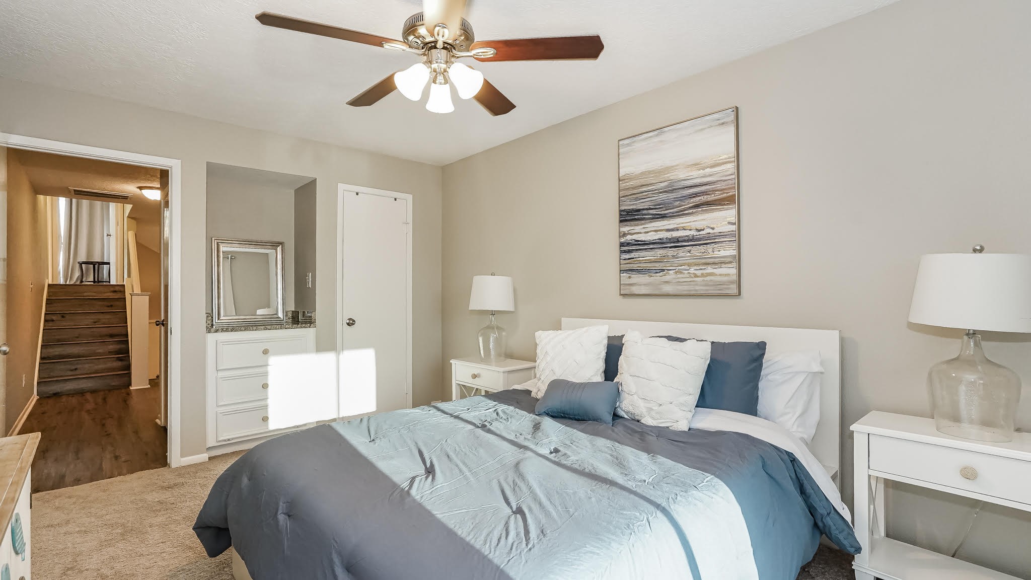 129 Capetown Conroe, TX 77356 - Photo 14 of 35 a bedroom with a large bed and a chandelier