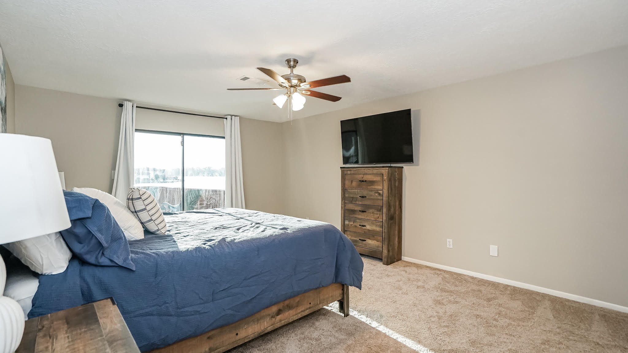 129 Capetown Conroe, TX 77356 - Photo 17 of 35 a bedroom with a bed and a flat screen tv