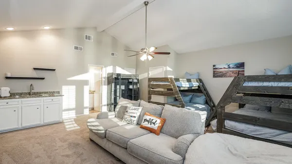 a living room with furniture and a ceiling fan