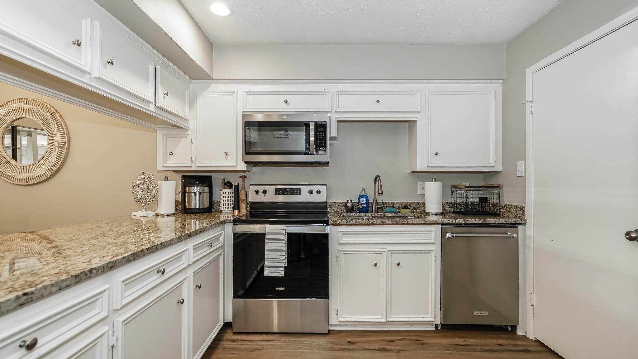 129 Capetown Conroe, TX 77356 - Photo 6 of 35 a kitchen with stainless steel appliances granite countertop a sink and stove top oven