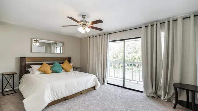 a bedroom with a large bed and a chandelier